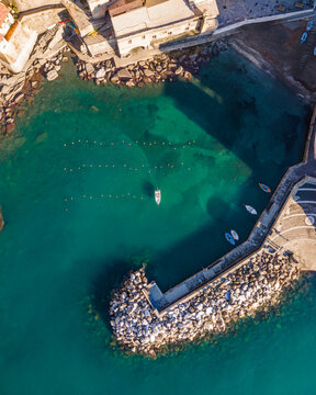Aerial view of a fishing boat docket along the pier in Vernazza, Cinque Terre, Liguria, Italy.