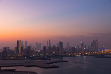 Manama city skyline at sunset in the Gulf country of Bahrain 