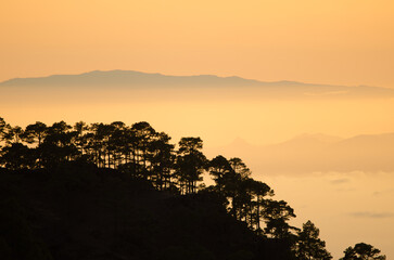 Alsandara Mountain in Gran Canaria in the foreground, south of Tenerife to the right and La Gomera in the background at sunset. Canary Islands. Spain.