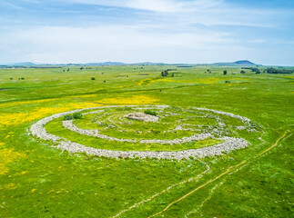 Aerial view of ancient megalithic monument in grassland, Rujum Al-Hiri, Golan Heights, Israel.
