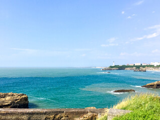 Fototapeta na wymiar Famous seaview of Biarritz, popular touristic resort in French Basque Country. Atlantic Ocean view from Biarritz coast. Summer. Basque Country. Turquoise blue water, lighthouse