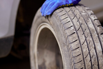 Changing the tires on the car close up. Seasonal needs for safety. Safety concept.