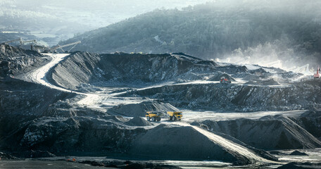 Crushing plant, mining trucks and loaders working at stone quarry, industrial landscape