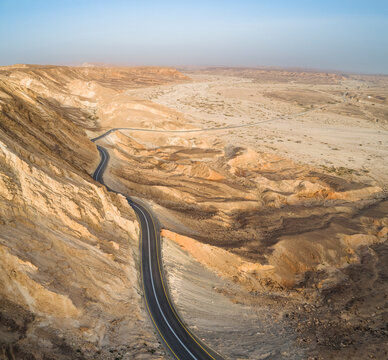 Aerial view of a winding road on a mountain side in the desert. Negev, Israel.