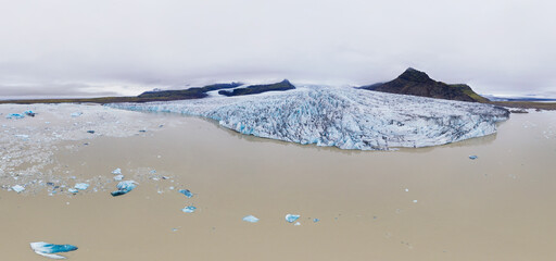 Aerial 240 degrees panoramic view of Fjallsarlon glacier lake with Fjallsjokull, glacier tongue of Vatnajokull glacier, Iceland.