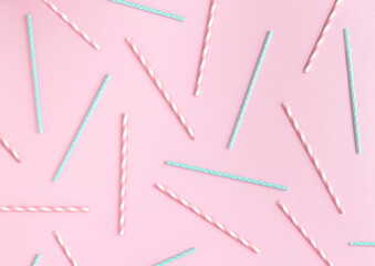 Retro pastel drinking paper straws pattern on pink background. Flat lay party backdrop