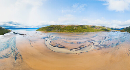 Aerial 180 degrees panorama of sandbanks in the fjord Kaldalon where water from the glacier Drangjokull flows towards the sea, Westfjords, Iceland.