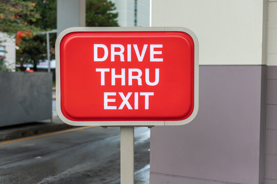 Drive Thru exit red sign near fast food restaurant or cafe