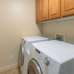 Square Small laundry room interior with wall-mounted drying rack