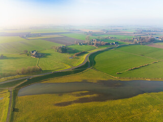 Aerial view of dike and partly flooded floodplains along the river IJssel, Welsum, Overijssel, Netherlands.