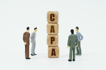 On a white background, figures of businessmen and wooden cubes with the inscription - CAPA