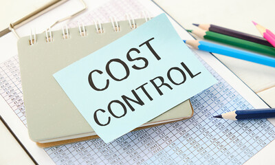 COST CONTROL text on paper with calculator,pen.