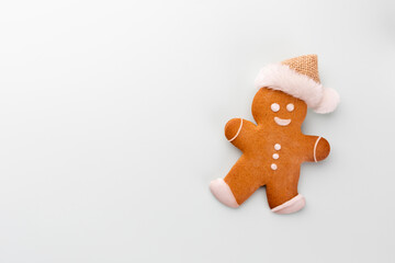 Gingerbread man, cookies and Christmas decor on pastel background.