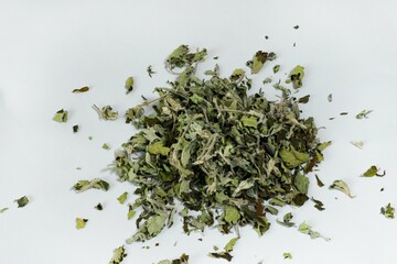 Heap of dried leaves for tea on a white background. Medicinal plants. Alternative medicine