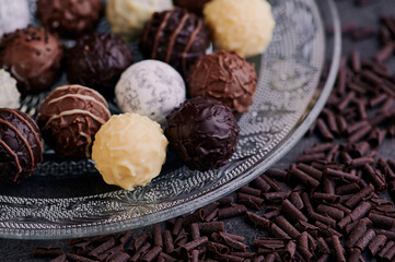 glass plate with chocolate truffles, macro color photo