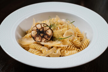 Pasta with herbs. Traditional Italian dish served on restaurant table.
