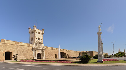 Fototapeta na wymiar Las Puertas de Tierra, Gate with tower in the old city walls of Cadiz