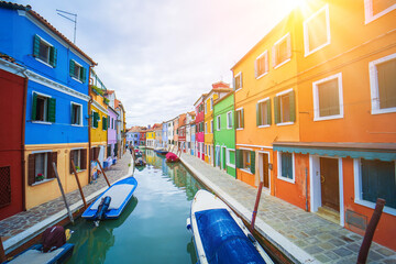 Fototapeta na wymiar View of streets with colorful houses in Burano along canal. Typical tourist place burano island in Venetian lagoon Italy. Beautiful water canals and colorful architecture. Burano Italy 7 october 2021