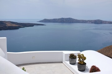 Various flower pots on the roofs of Santorini Greece