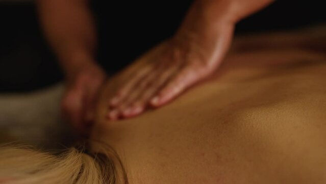 Close-up of a back massage at a spa. A woman is getting a back massage.