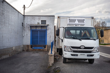 Delivery van in front of a small business building
