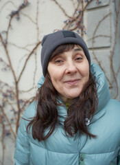Portrait of happy senior woman in warm clothes and hat. 