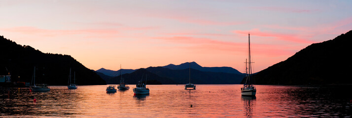 Panoramic Photo of Sailing Boats Silhouetted in Picton Harbour at Sunset, South Island, New Zealand