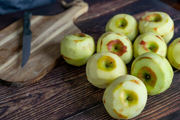 Peeled apple for  apple tart or pie on wood table background.