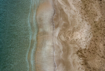 Aerial view drone of empty tropical sandy beach with golden sand. Seascape background