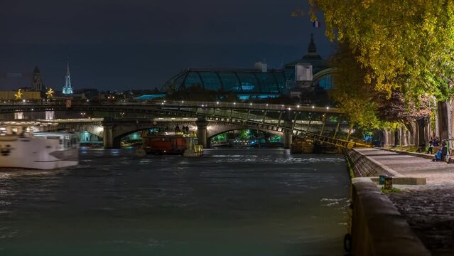 Enlightened Docks With Peoples Walking on Them in Paris Seine River and Tourists Cruises