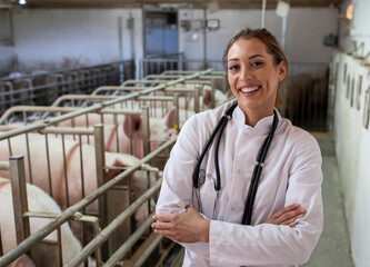 Veterinarian with crossed arms in pigpen