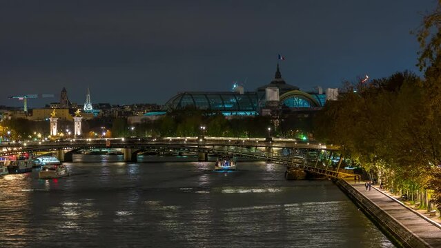 An Above View of Seine River at Paris at Night Tourists Cruises and Peoples on Docks