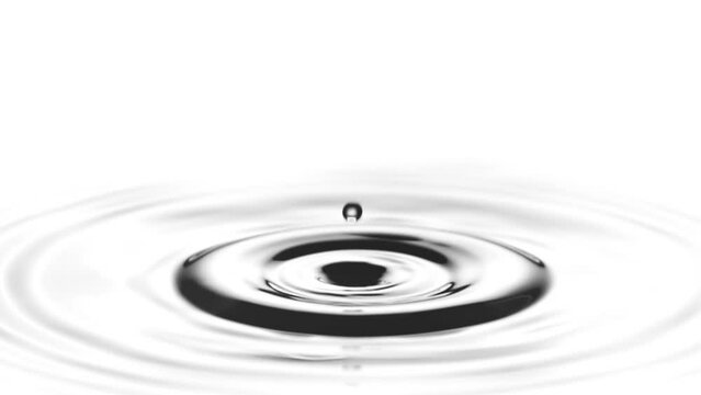 A single drop of water falling into a pool of water in slow motion.