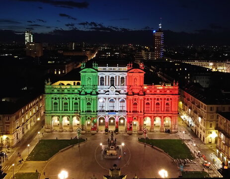 National Museum of the Italian Risorgimento with the façade illuminated by the colours of the Italian flag. Turin, Italy - March 2021