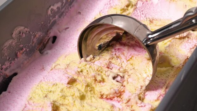 4K - ice cream scooper picks up ice cream. Close-up
