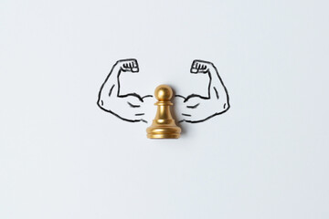 The concept of a business strong person. Arms muscles drawn with a pawn chess piece.