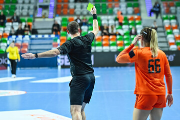 Referee shows yellow card during women handball match