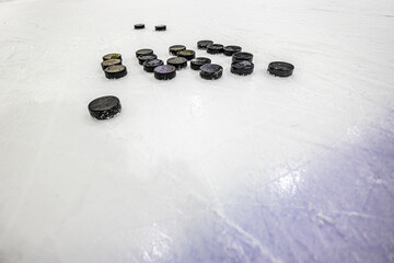Obraz na płótnie Canvas pucks on empty ice rink