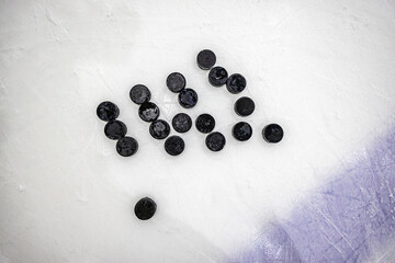 pucks on empty ice rink