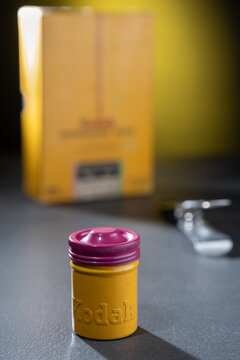 Vintage tin 35mm film canister from the 1070s and retro photographic paper labelled with Kodak Eastman logo.