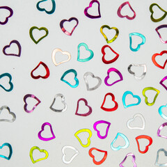 Minimal Valentine's day idea. Metallic hearts on white background. Creative love pattern concept.