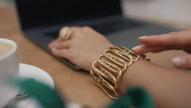 girl stroking jewelry on her wrist