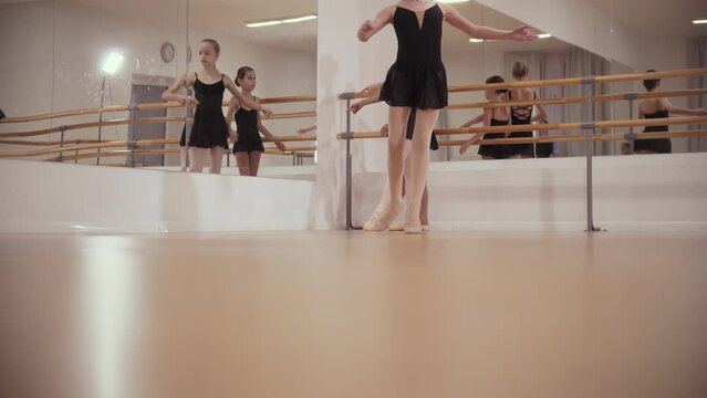 Ballerina girls in black dresses dancing in the studio