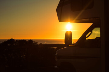 Camper Van Motor Home in Front of the Sea During Sunset
