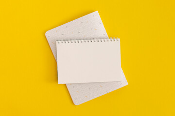 Notebook on yellow background. Top view. Flat lay. Back to school concept.