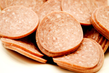 Close-up of Hard Salami slices in a White bowl