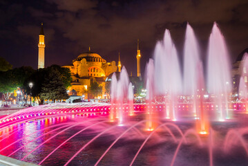 Fototapeta na wymiar Hagia Sophia (Aya Sofya) and Sultanahmet Square fountains at night, Istanbul, Turkey, Eastern Europe