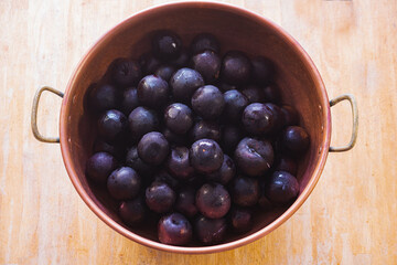 plums in copper pan