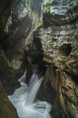 Fototapeta na wymiar Skocjan Caves, Slovenia. Waterfall at the bottom of the 'Big Valley' (Velika Dolina), Karst Region of Slovenia, Europe