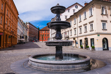 Ljubljana, fountain on the Breg Embankment at Novi Trg in the centre of Ljubljana, Slovenia, Europe - obrazy, fototapety, plakaty